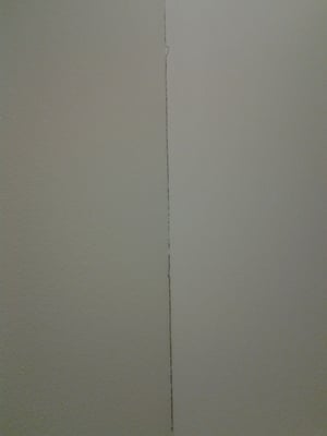 Picture of a large crack in a plaster wall