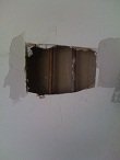 Place the drywall patch with mesh strips in the hole