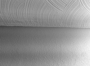 Photo of swirl drywall texture on the ceiling and knockdown texture on the wall